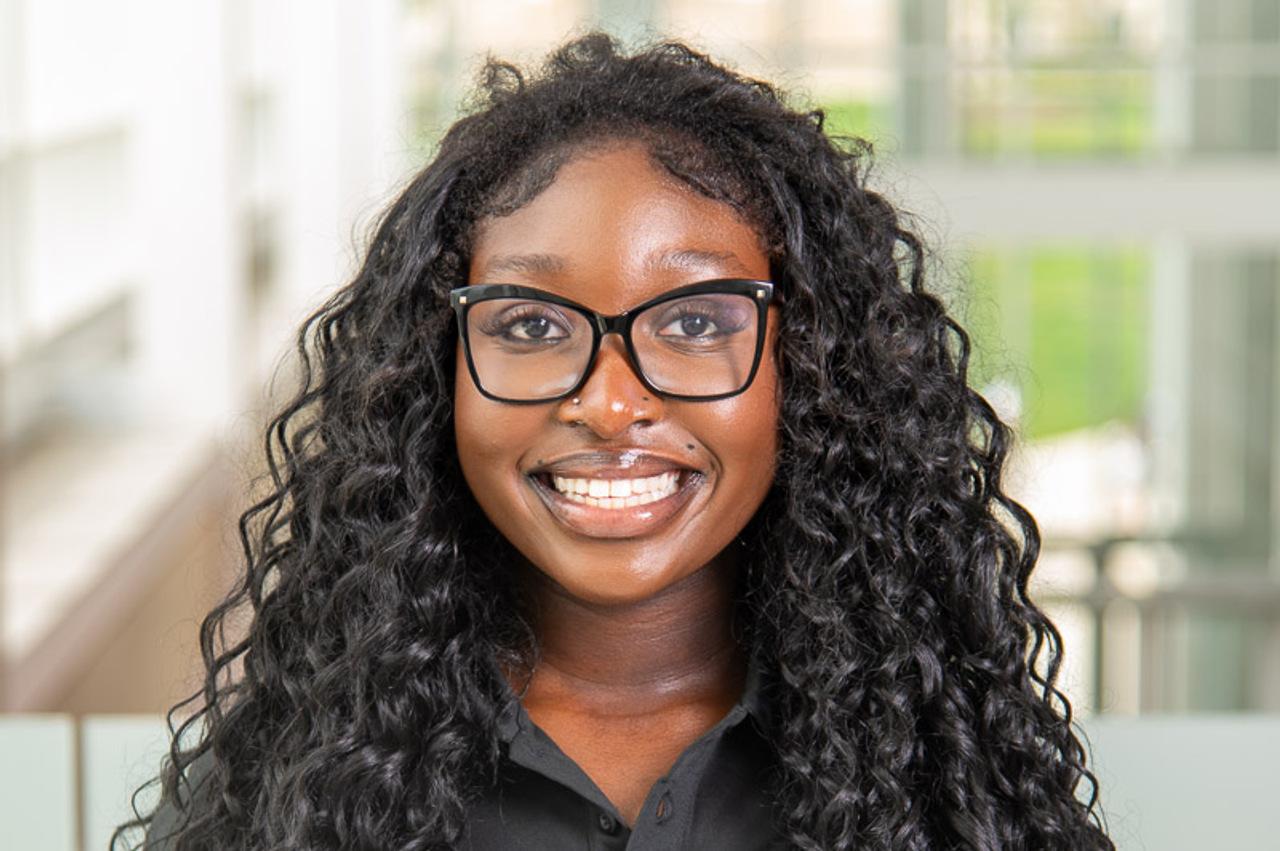 TA Gabrielle with black glasses and silver stud nose piercing
